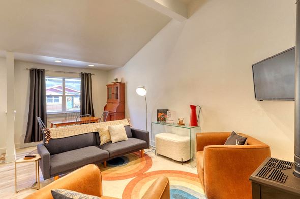 Pagosa Springs apartment for rent - A living room with a grey couch and a brown armchair.