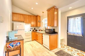Pagosa Springs apartment for rent - A kitchen with wooden cabinets and a white refrigerator.