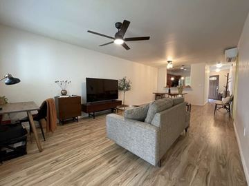 Kapolei apartment for rent - A living room with a grey couch and wooden floors.