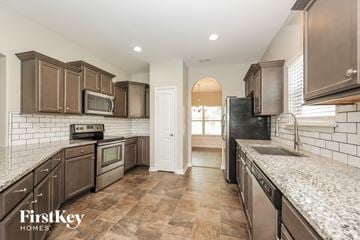 Murfreesboro house for rent - A kitchen with brown cabinets and a white countertop.