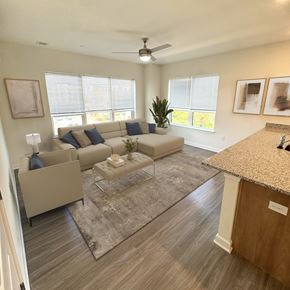 Newark apartment for rent - A living room with a couch, a coffee table, and a ceiling fan.