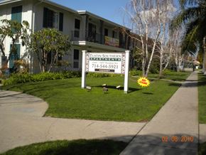 Tustin apartment for rent - A sign for Tustin Southern Apartments stands in front of a building.