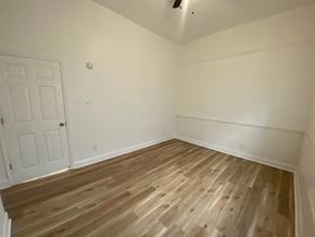 Louisville house for rent - A room with wooden flooring and a white door.