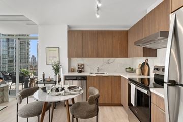 Coquitlam apartment for rent - A modern kitchen with a dining table and chairs.