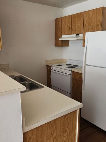 Salem apartment for rent - A kitchen with a white fridge, stove and oven.