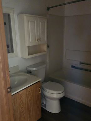 Salem apartment for rent - A white toilet sits next to a sink in a small bathroom.