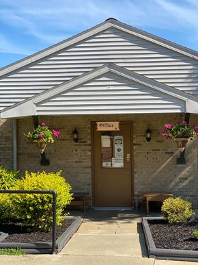 Salem apartment for rent - The front of a building with a brown door and a sign that says Office.