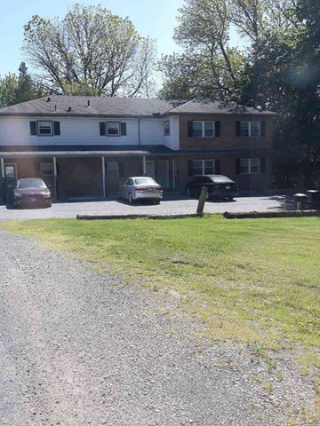 Mohnton apartment for rent - A house with a gravel driveway and a car parked in front.