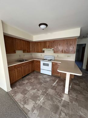Shillington apartment for rent - A kitchen with a white oven and brown cabinets.