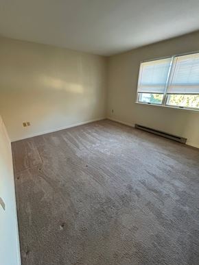 Shillington apartment for rent - A room with a carpeted floor and a window with blinds.