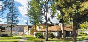Placentia apartment for rent - A house with a brown roof and a white car parked in front.