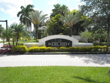 Coral Springs apartment for rent - A sign that says Palms Point in front of some trees.
