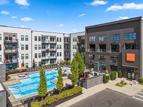 Columbus apartment for rent - A large building with a pool in front of it.