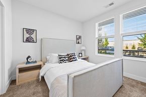 Columbus apartment for rent - A bedroom with a large bed and a window overlooking a balcony.