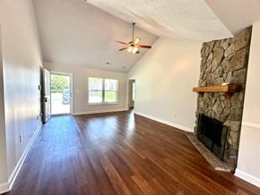 Boiling Springs house for rent - A room with a stone fireplace and wood flooring.