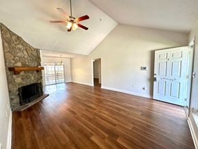 Boiling Springs house for rent - A room with a stone fireplace and wood flooring.