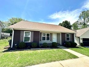 Boiling Springs house for rent - A house with a brown roof and grey siding is surrounded by a well-kept lawn.