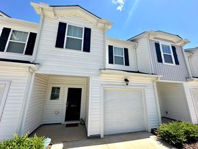 Greenville house for rent - A white house with black shutters and a black door.
