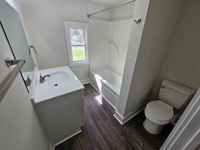 Lima apartment for rent - A white sink in a small bathroom with wood flooring.