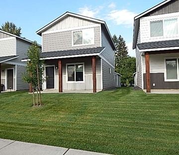Rathdrum house for rent - A small tree is in the front yard of a house.