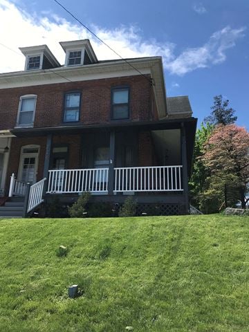 Wernersville house for rent - A red brick house with a white porch.