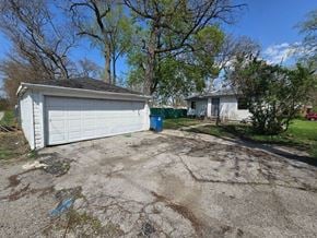 Gary house for rent - A white garage door is open and the garage is white.