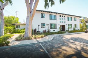 Eagle Rock apartment for rent - A white two-story house with a driveway in front.