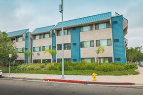 Van Nuys apartment for rent - A building with blue and beige panels and a red fire hydrant in front.