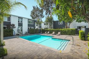 Studio City apartment for rent - A swimming pool surrounded by a brick patio and lounge chairs.