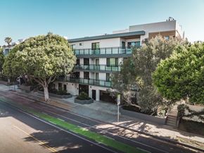 Santa Monica apartment for rent - A street view of a residential area with apartment buildings and trees.