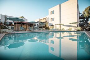 Pasadena apartment for rent - A large swimming pool in front of a building with a sunny day.