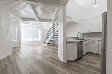 Reseda apartment for rent - A modern kitchen with a staircase leading to the upper floor.