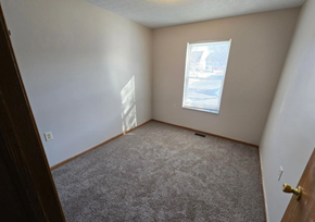 San Antonio apartment for rent - A room with a carpeted floor and a window showing a snowy scene outside.