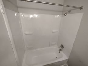 San Antonio apartment for rent - A white bathroom with a white tub and a white shower curtain.