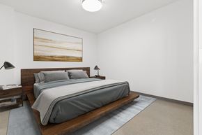 Southgate apartment for rent - A bedroom with a large bed and a painting on the wall.