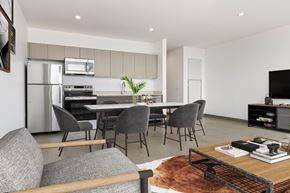 Southgate apartment for rent - A modern kitchen with a dining table and grey chairs.