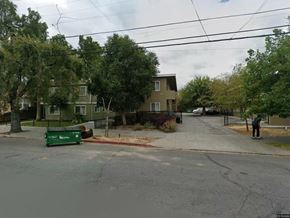 San Jose apartment for rent - A street view with a green trash bin on the sidewalk.
