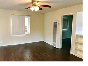 San Jose apartment for rent - A room with a ceiling fan and a window with blinds.