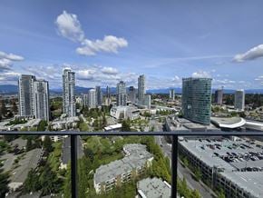Surrey apartment for rent - A cityscape with tall buildings and a parking lot.