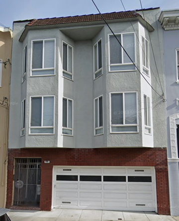 San Francisco apartment for rent - A two-story building with a garage door and a brick wall.