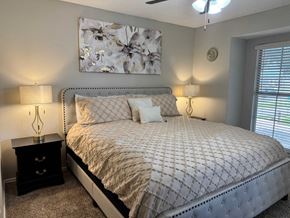 Irving house for rent - A bedroom with a large bed and a painting above it.