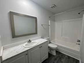 Columbia apartment for rent - A bathroom with a toilet, sink, and mirror.