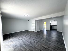 Columbia apartment for rent - A spacious room with wooden flooring and white walls.