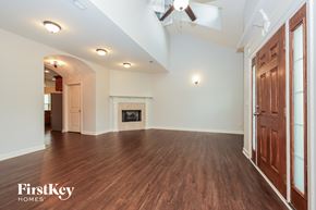 Murfreesboro house for rent - A spacious room with wood flooring and a fireplace.
