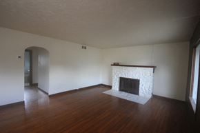 Whitefish apartment for rent - A room with a fireplace and wood floors.