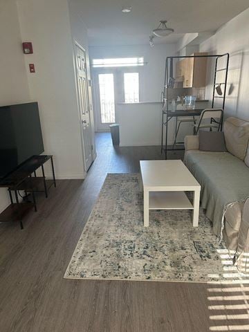Calgary apartment for rent - A living room with a white sofa and a rug.