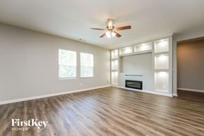 Bethlehem house for rent - A spacious room with a fireplace and a ceiling fan.