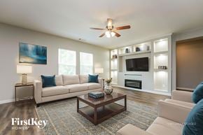Bethlehem house for rent - A living room with a couch, a coffee table, and a ceiling fan.