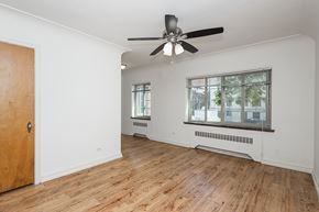 Denver apartment for rent - A room with a ceiling fan and wooden flooring.