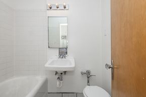 Denver apartment for rent - A white sink with a mirror above it in a bathroom.